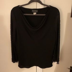 Women’s beaded, long sleeved, formal blouse in black.